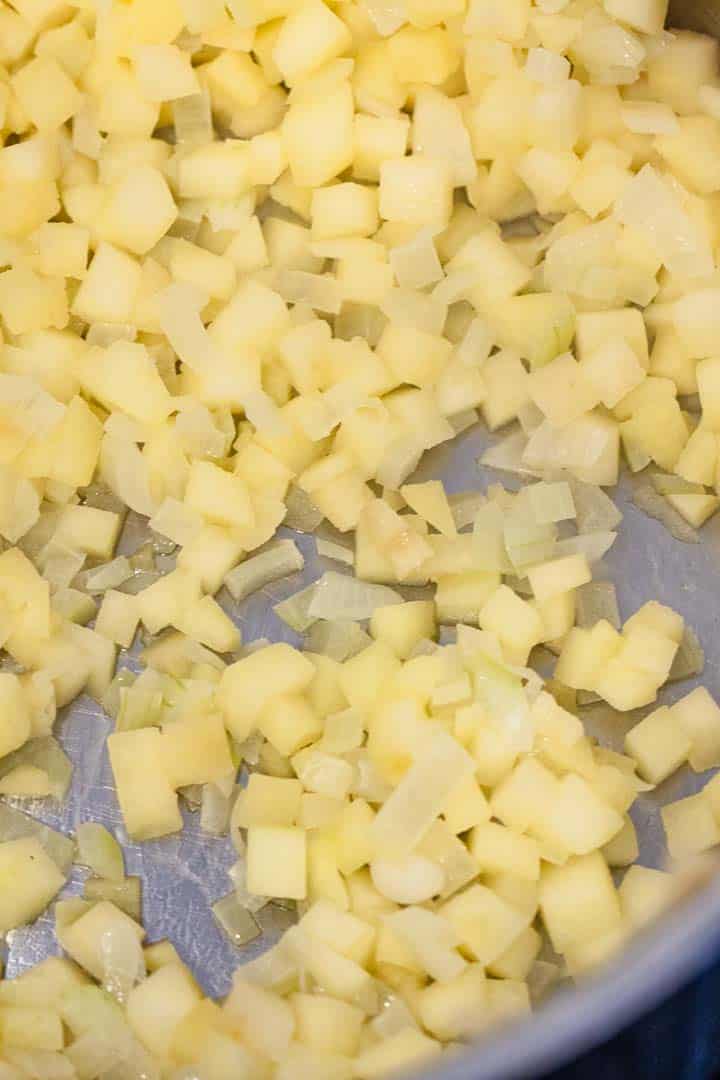 Diced apples in a skillet.